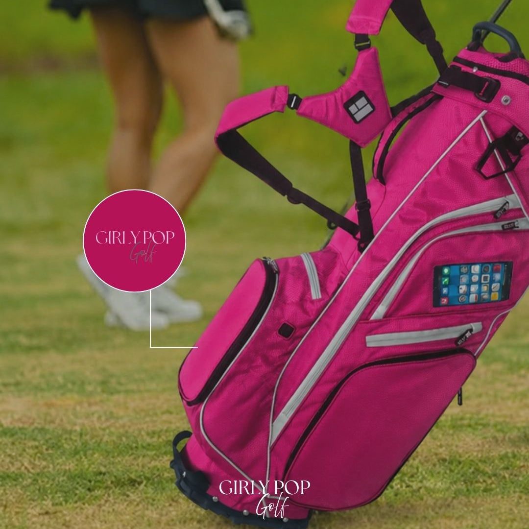 A member walking the fairway behind the hot pink Girly Pop stand bag.